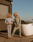 Temperature regulating Babu Merino Pyjama sets worn by two children in New Zealand on a cold morning.