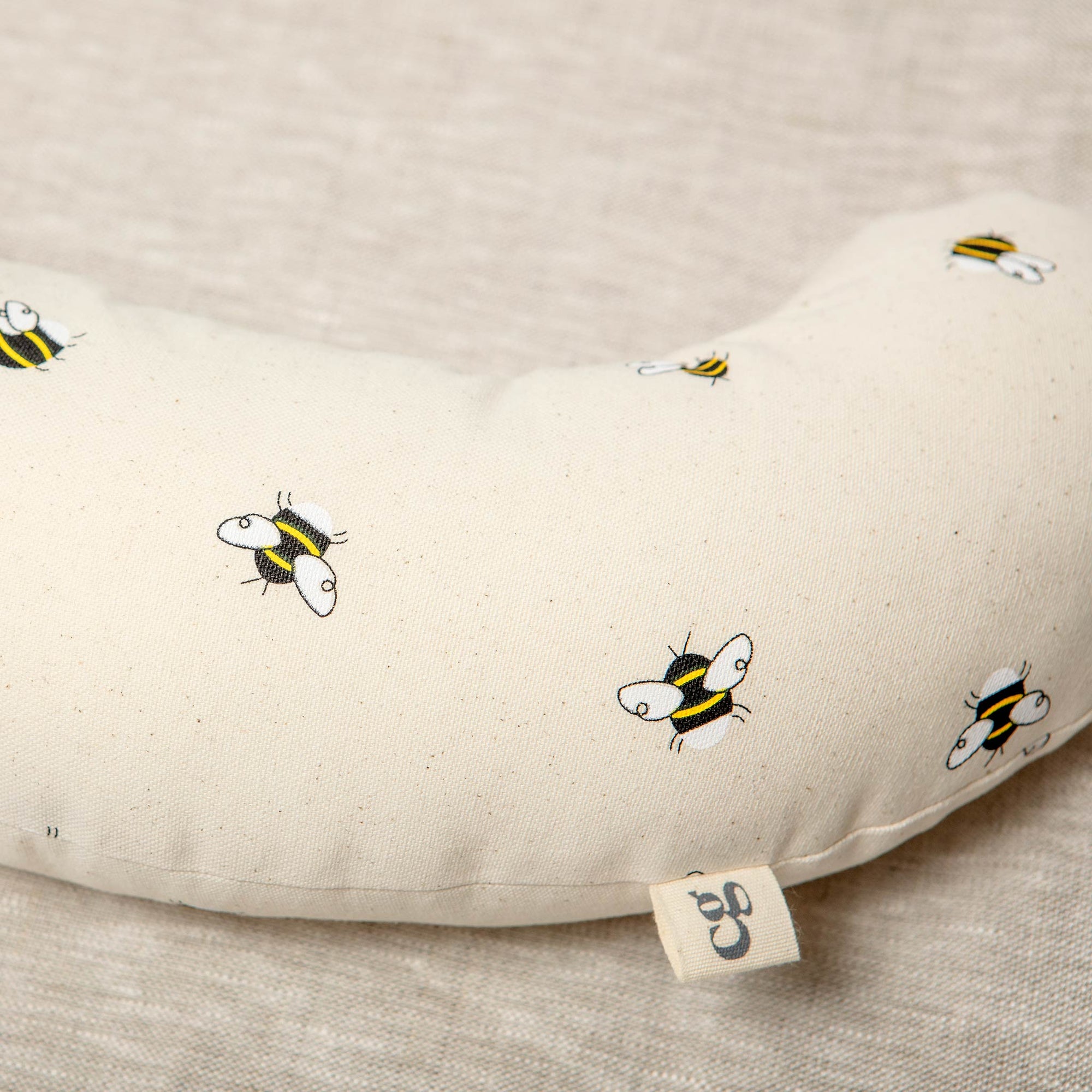 Made from a supportive wooden lining and a washable cotton cover with bees printed on it. The Bee tummy time support aid helps newborn babies during their floor time. 