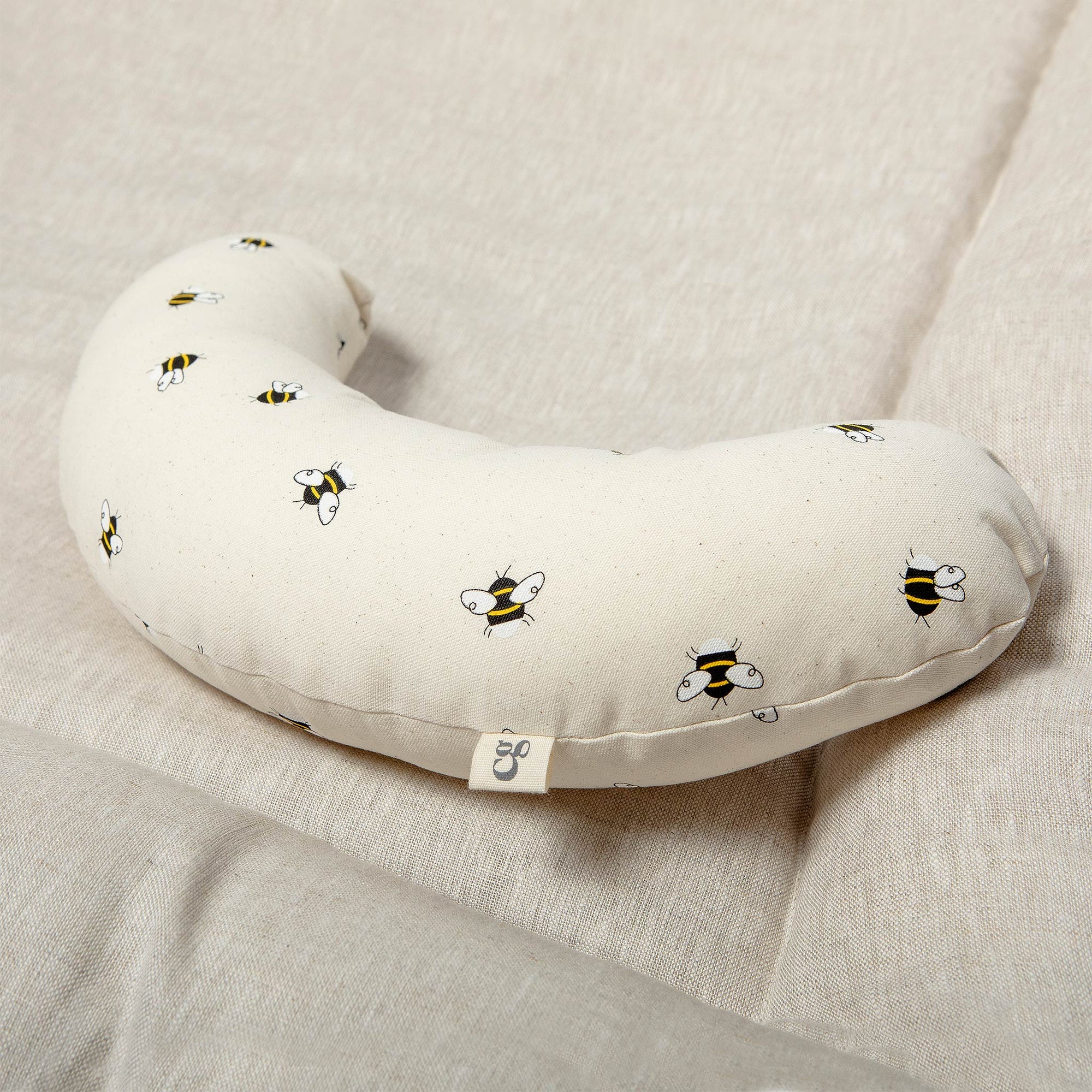 The Bee tummy time support aid is made from a supportive wooden lining and a washable cotton cover which helps newborn babies during their floor time.