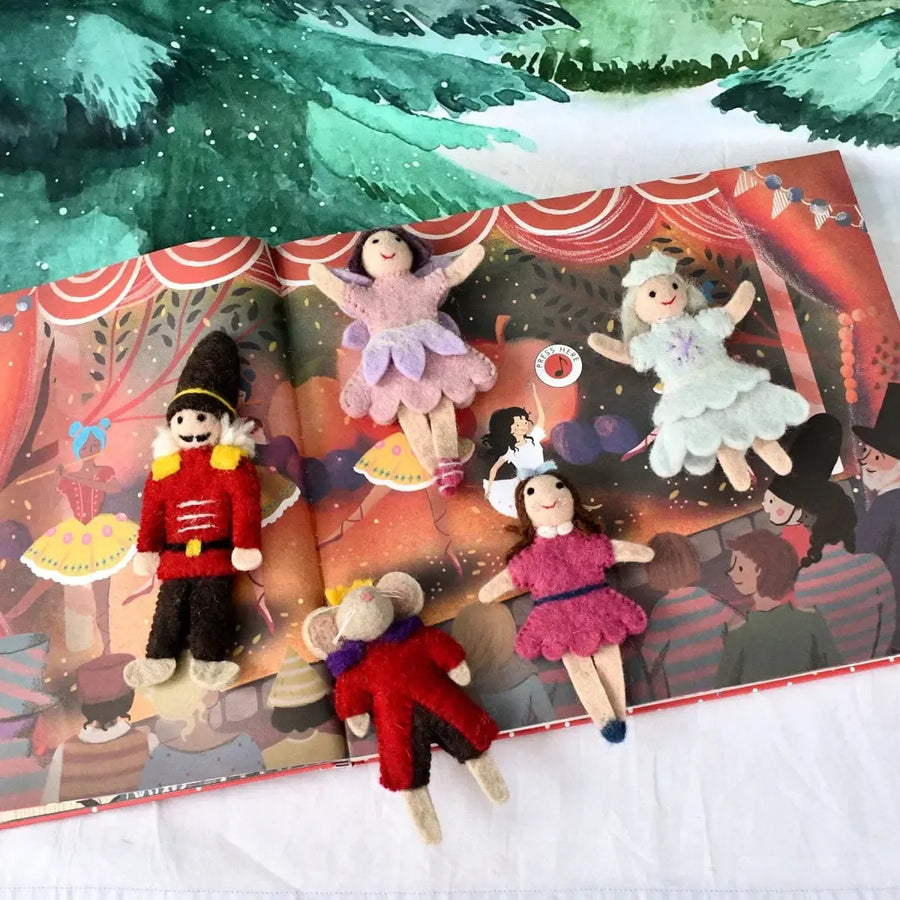 Puppet theater with puppets in front of a scenic backdrop