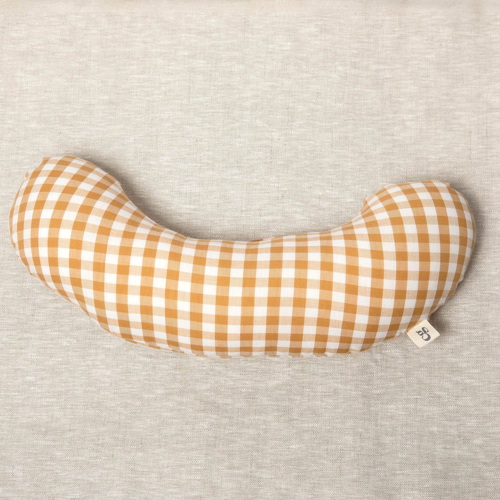 The Sonny Tummy Time support aid helps babies during floor time in their early months. Sewn in a mustard check cotton fabric.