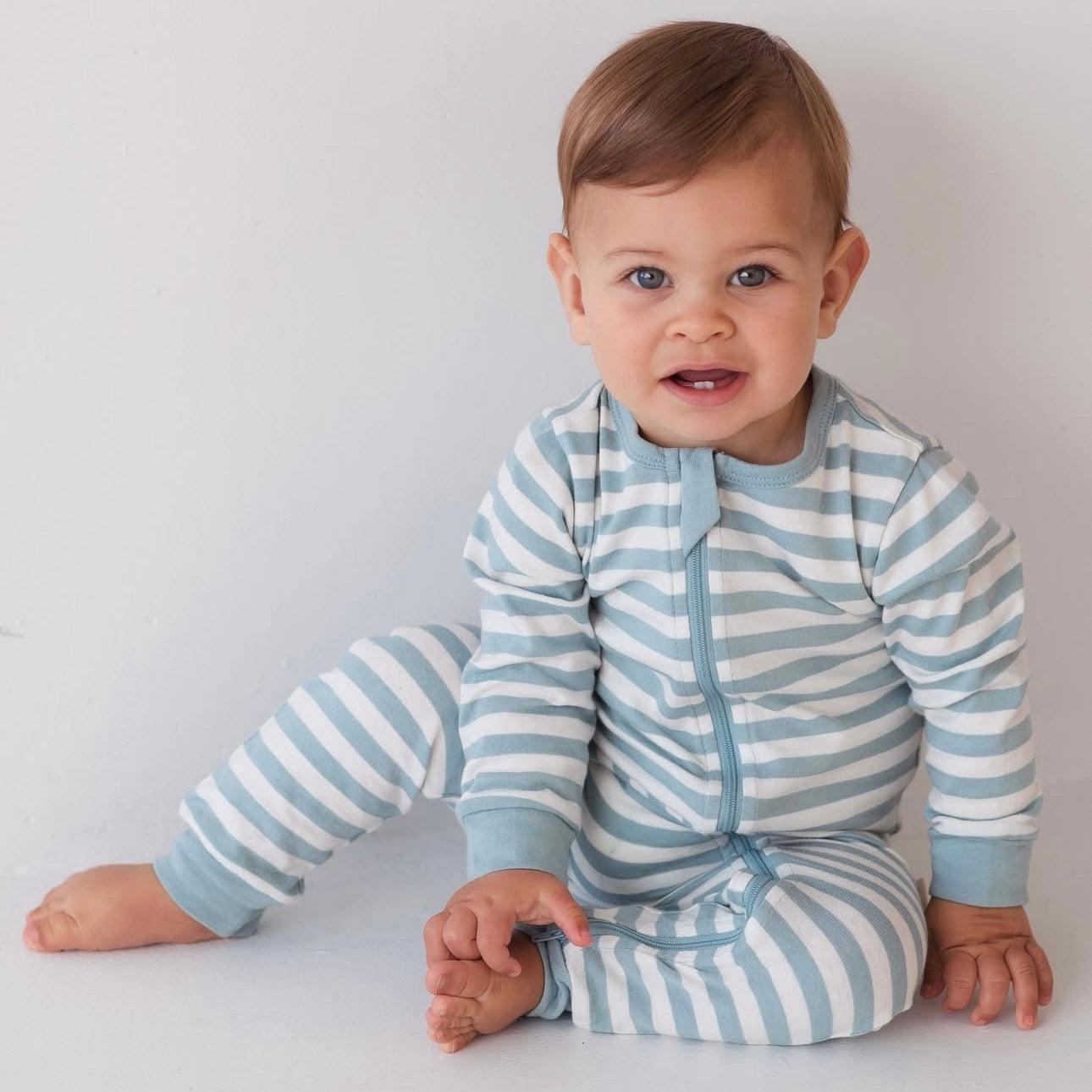 Baby wearing Woolbabe Pyjama Zip Suit for safe sleep and easy Nappy changes